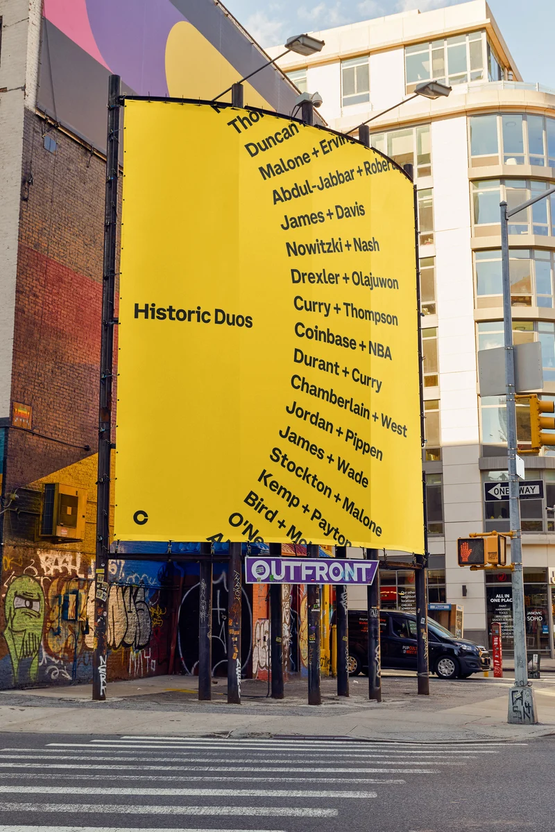 Coinbase yellow poster on a city building