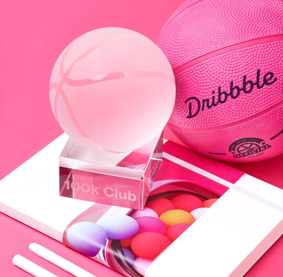 Pink Dribbble ball object with the wordmark