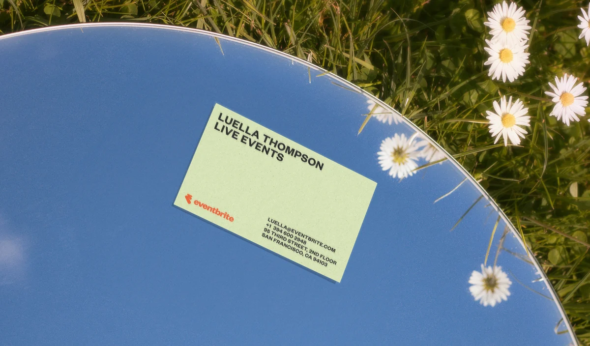 Eventbrite card on a blue surface with flowers
