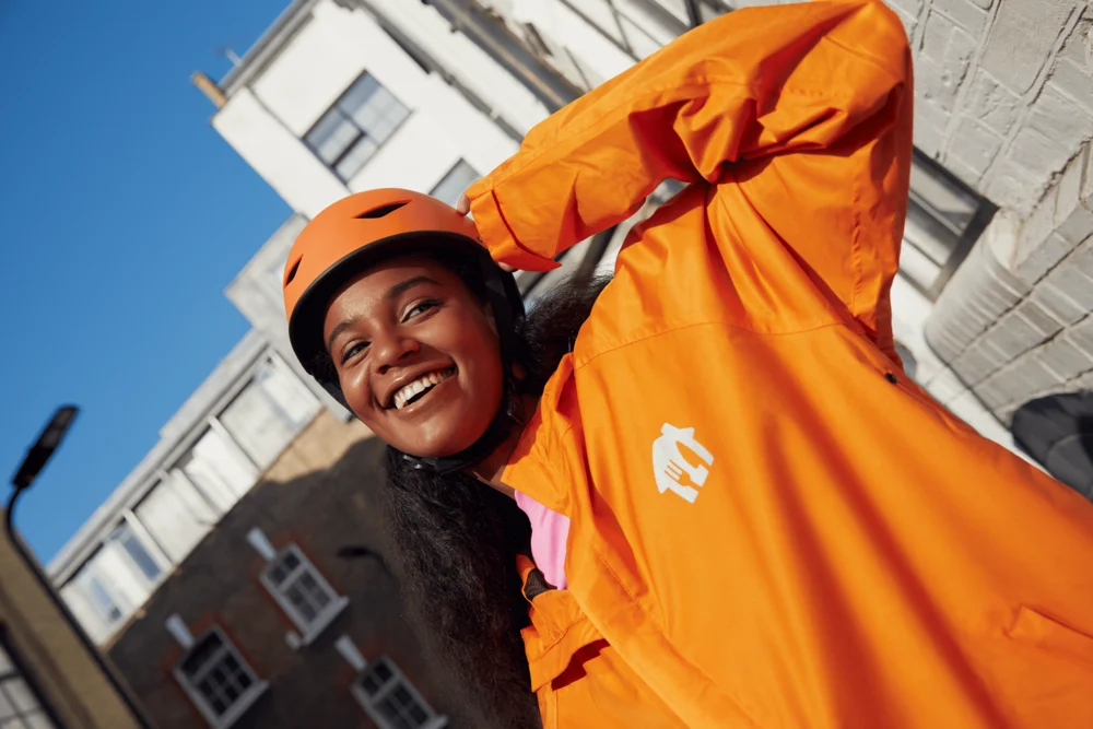 Just Eat courier smiling in orange