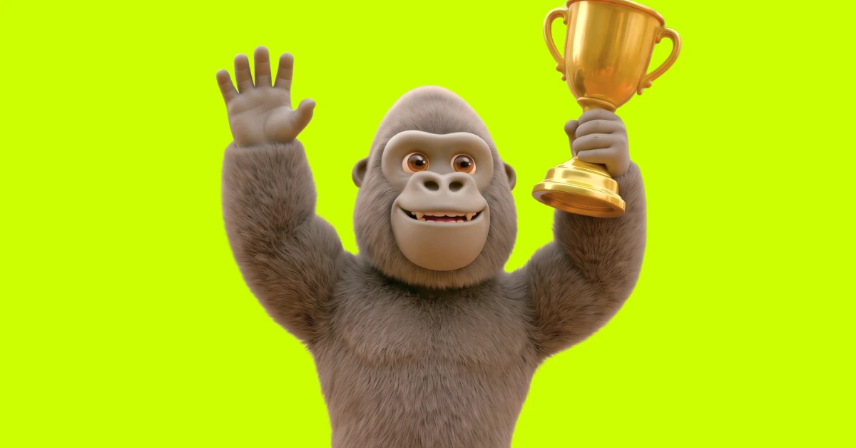 Kong gorilla mascot holding up a gold trophy on acid-green