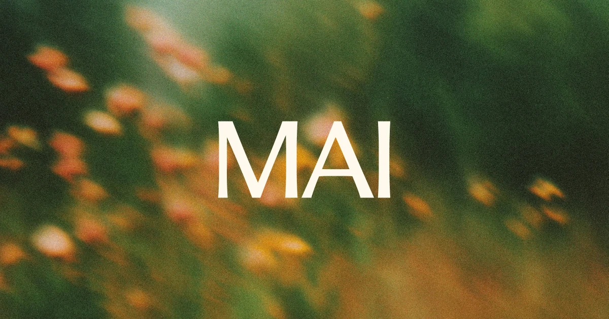 'MAI' wordmark over a soft-focus field of orange flowers