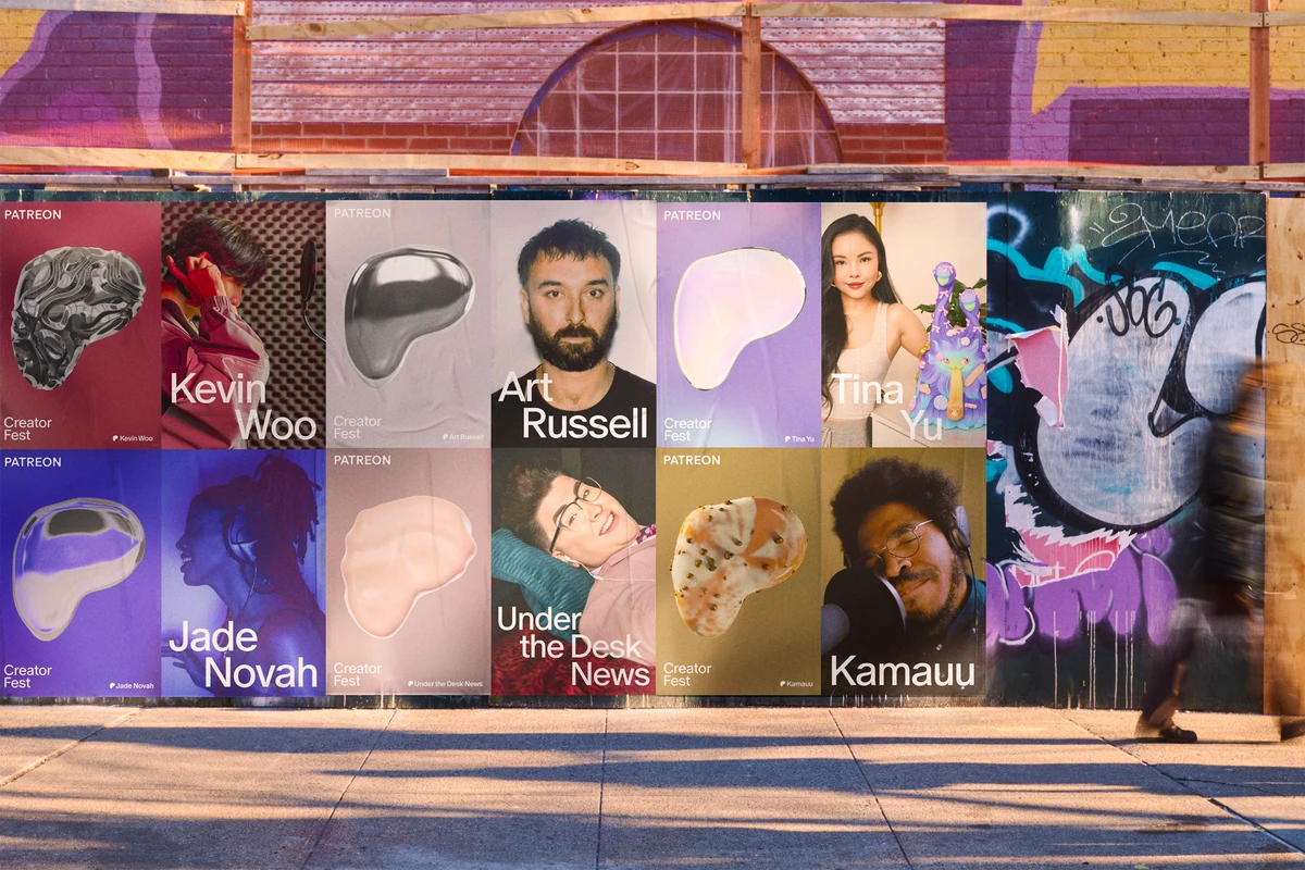 Pared de carteles con retratos de creadores de Patreon en una calle