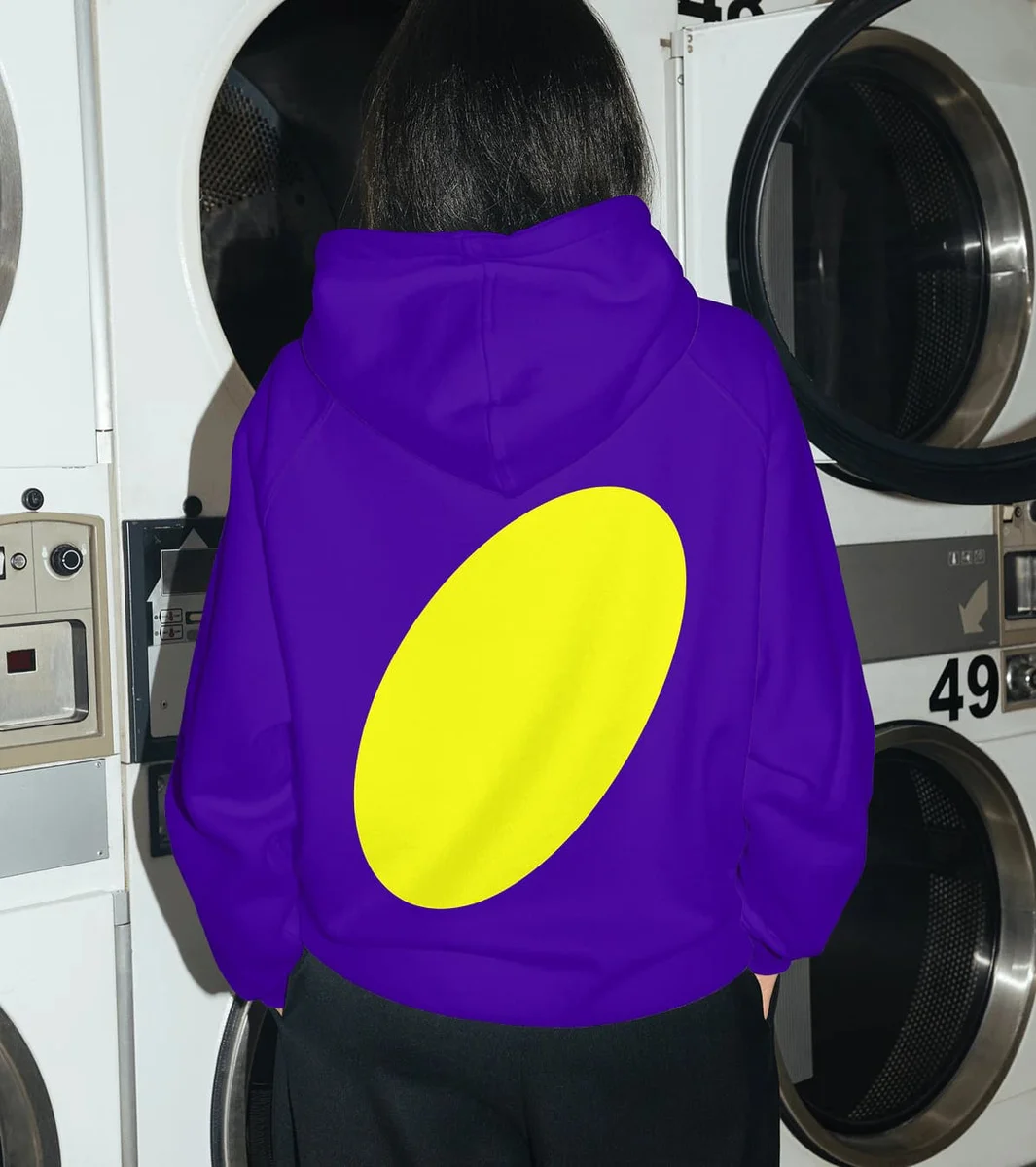 Purple Tubi hoodie in a laundromat